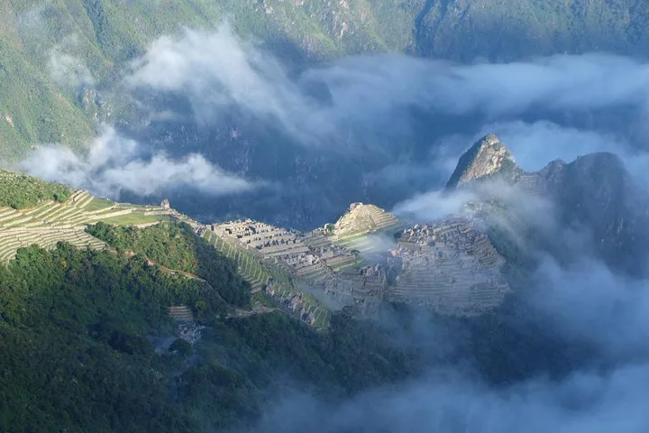 Hiker above a green Andean valley on a private 5-day luxury Inca Trail tour to Machu Picchu, Cusco, Peru