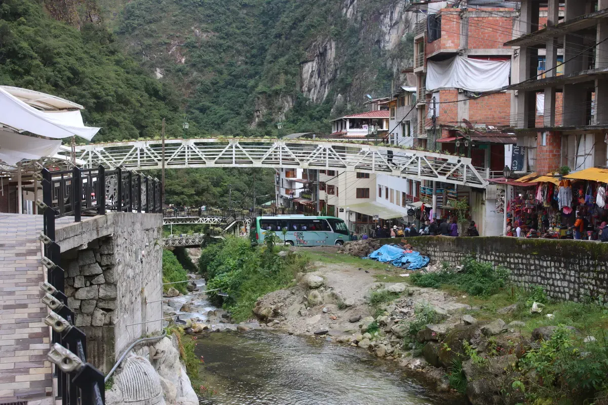 The river and footbridge in Aguas Calientes, seen on a private Inca Trail tour