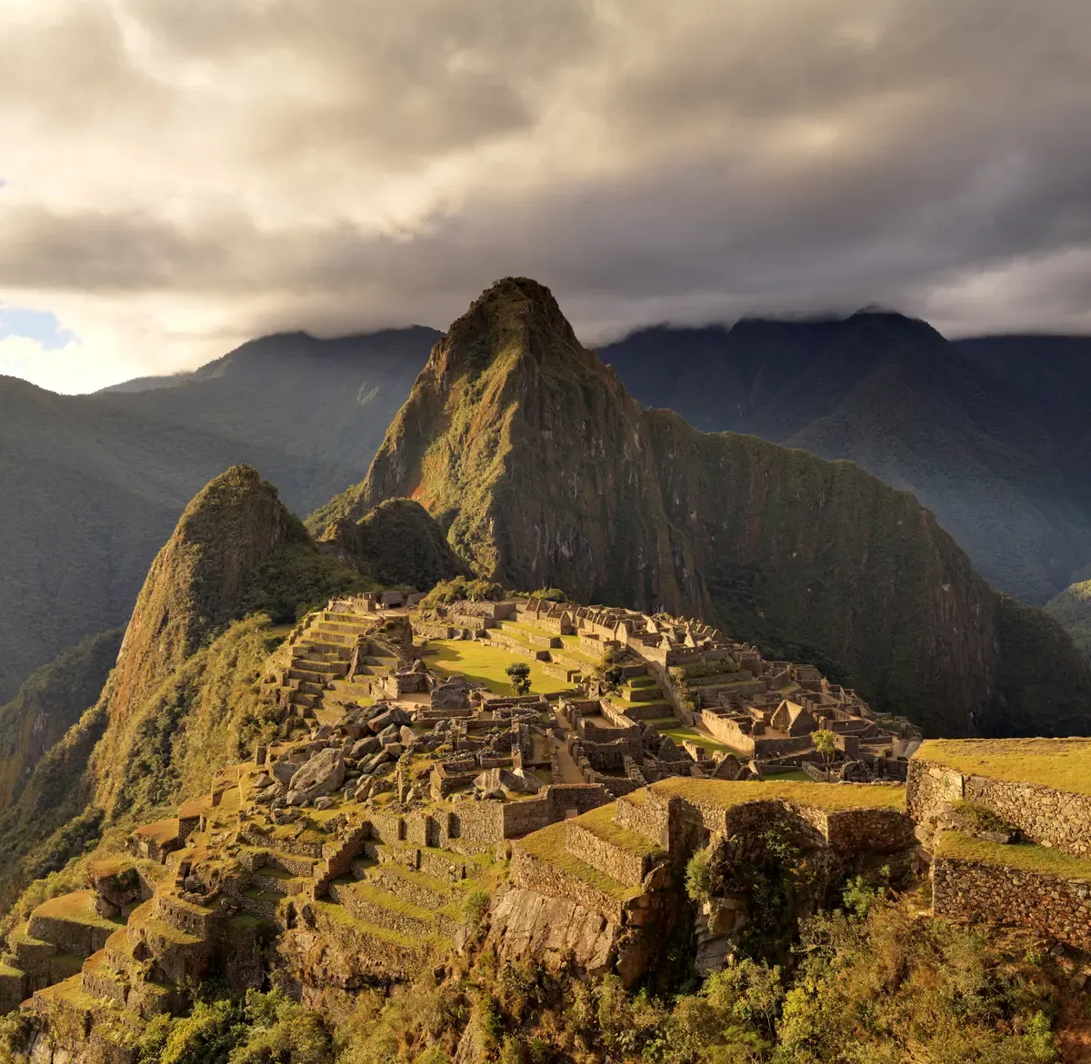 Huayna Picchu rising behind the Machu Picchu terraces at dusk, seen on a 2-day Inca Trail tour