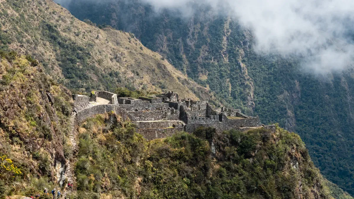 The Sayacmarca ruins on a cliff spur above the cloud forest, on the Inca Trail